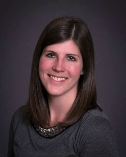 Woman in sweater in front of grey background